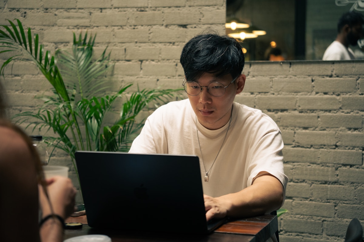 Filipino entrepreneur reviewing campaign analytics on laptop at a cafe